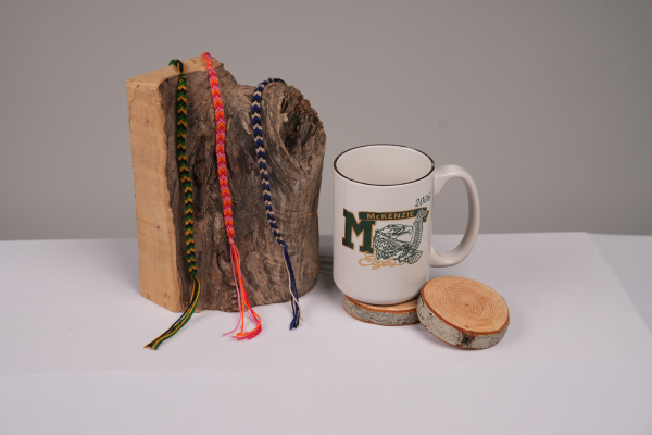bracelets on log and coffee mug on wooden coasters
